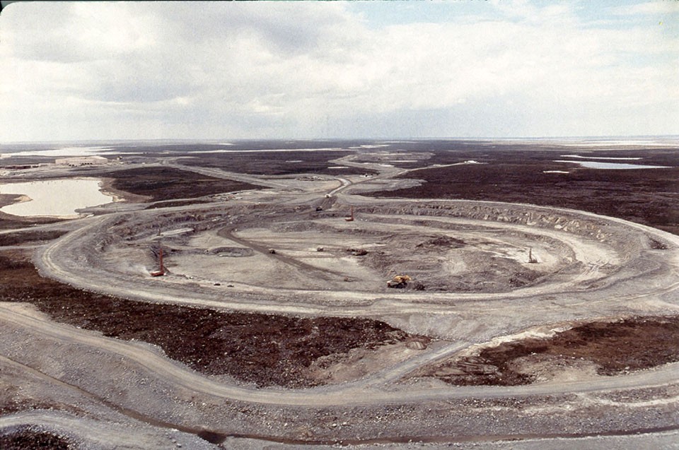 Start of the Ekati Diamond Mine, 1998. Eruptions of diamond-bearing rock formed craters that were later filled in by small lakes; miners drain the lakes, then dig straight down. The derricks in the middle are about three stories high. (Hugo Dummett) 15