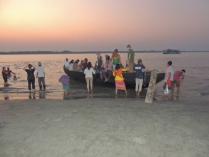 As the sun sets, we climb into the launch to leave the island and return to the Kokilmoni