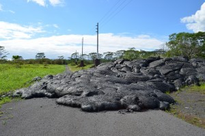 Lava laps across a road near the town of Pahoa. The latest eruption, which started in summer 2014, is not over; it may still overrun larger parts of town.