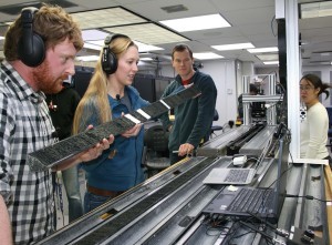 Researchers examine cores of sediment drilled from the deep seabed.
