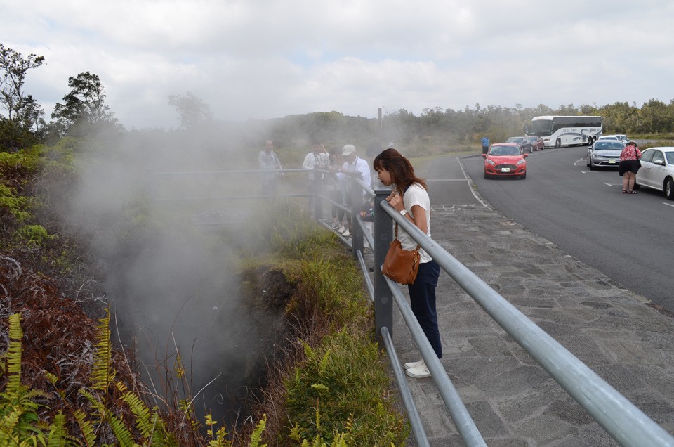 Hawaii Volcanoes National Park encloses much of Kilauea, and it sees 2 million visitors a year. At a popular roadside stop, tourists can get up close to a steam vent. 5