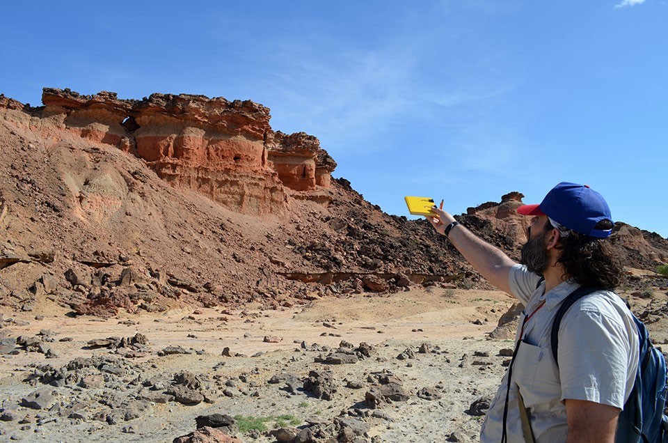 Near the Turkwel River, Lamont-Doherty geologist Christopher Lepre surveys layers of rocks and sediments dating back about 3.6 million years. In many places, wind, water and tectonic forces have shredded the surface into badlands, exposing many seque 4