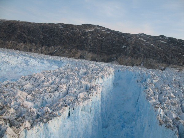 A rift opens near the front of Greenland's Helheim glacier. As giant chunks of ice fall off into the ocean, they produce seismic signals that may be used to estimate how much ice is being lost. (Photo by Meredith Nettles)