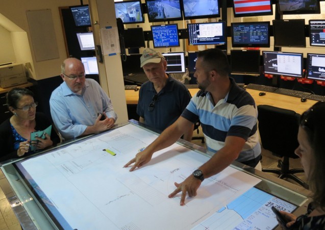 Bobby Kaprowski shows visitors a chart of the seismic streamer system used for a recent survey.