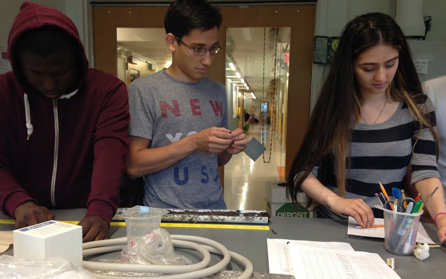 In the lab at Lamont, Atsu Bedjean, Ivan Carrasquillo and Areej Haroon jot down data from a core sample. They worked with Lamont researcher Dorothy Peteet to study the ability of the marsh's soils to store carbon. SSRFP 2015 Lab Work