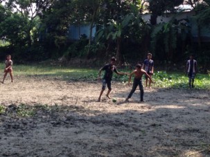 Kids playing soccer on the open field where we did our first auger hole.  The auger was hit by the ball several times.