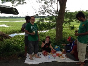 Eating a picnic lunch in the field at side of the road.  Vans on either side protected us.  We usually had bananas, oranges, crackers, cakes and on this day pineapple as well.