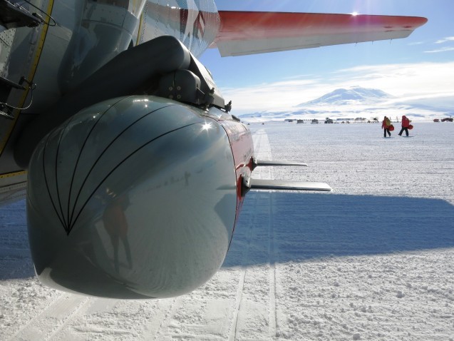 Moving across the ice with IcePod in the front and active Volcano Mt. Erebus in the distance.
