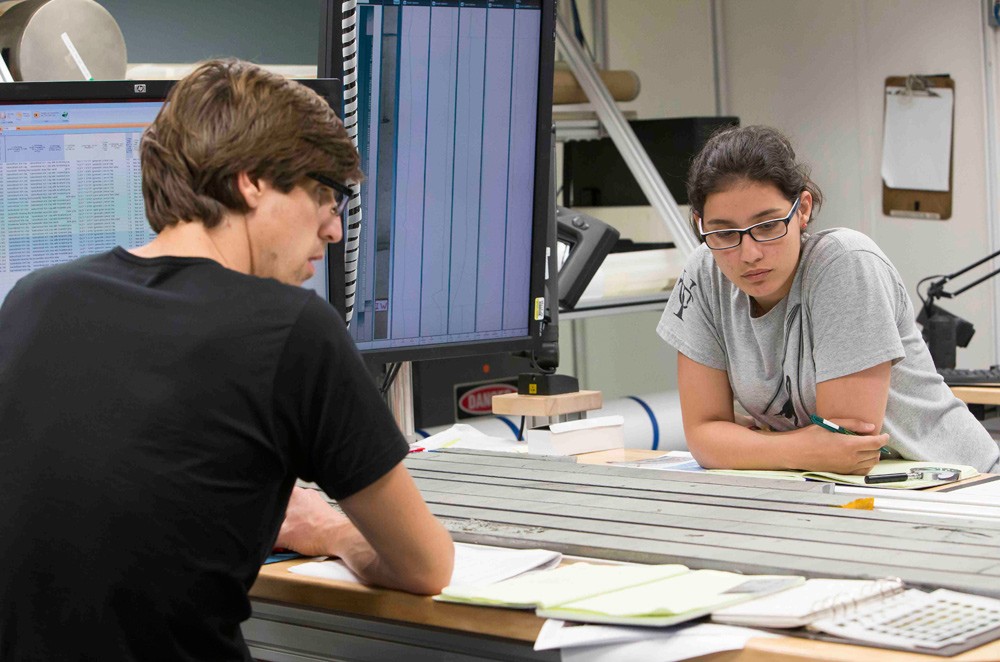 Sedimentologists Julien Crespin of the University of Bordeaux and Alejandra Cartagena-Sierra of Notre Dame take down descriptions of the core. (Tim Fulton) julien-crespin-alejandra-cartagena-sierra-core-tim-fulton