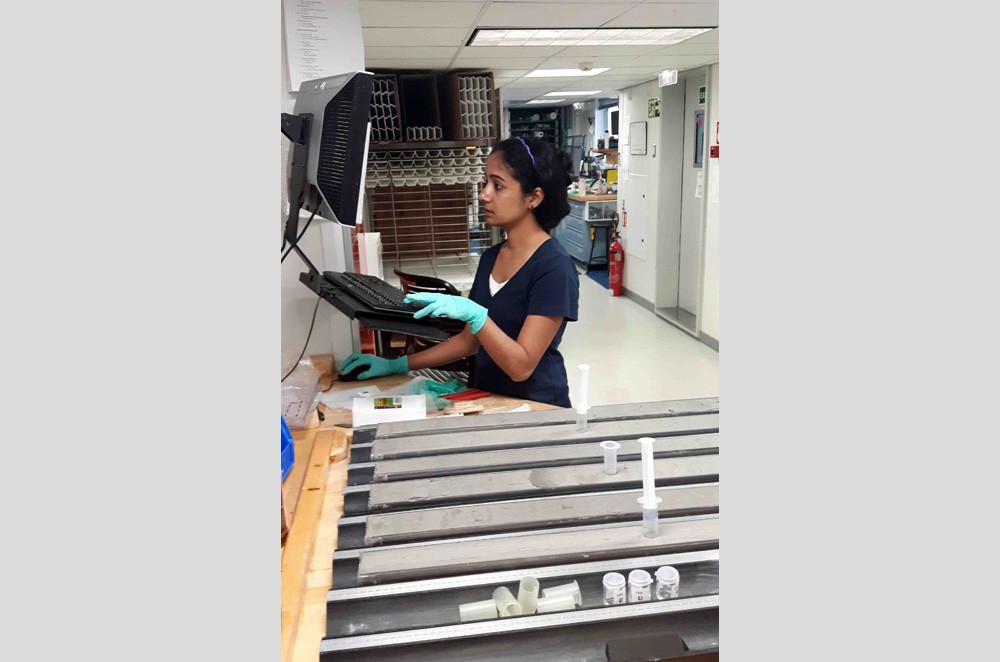 Nambiyathodi Lathika, a physical properties specialist from India's National Centre for Antarctic and Ocean Research, enters core data at the sample table. (Jens Gruetzner) lathika-sample-table-gruetzner