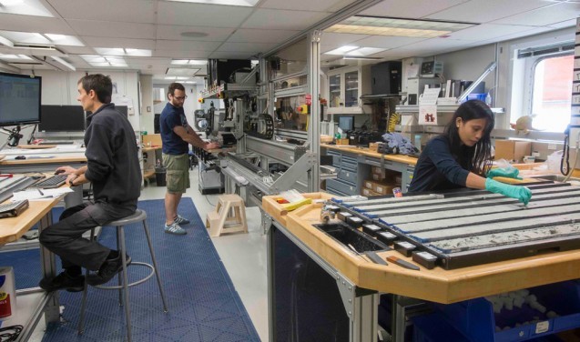 Sedimentologists Thibaut Caley of the University of Bordeaux and Andreas Koutsodendris of the University of Heidelberg and Deborah Tangunan, a paleontologist from the University of Bremen, work in the core lab aboard the JOIDES Resolution. Photo: Tim Fulton/IODP.