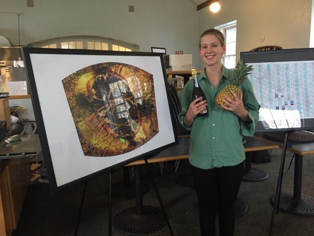 DEES graduate student Anna Barth poses with her award winning image of a thin section micrograph of garnet and mica.