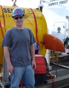 Carl Kaiser stands in front of Sentry during an earlier mission in which the AUV became entangled in rope . Photo courtesy of Carl Kaiser.
