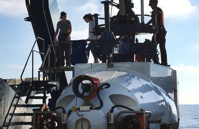 Stephanie Bush of Monterey Bay Aquarium Research Institute (left) and Chiara Borelli of the University of Rochester emerge from the research submarine Alvin after the first dive. Photo: Bridgit Boulahanis