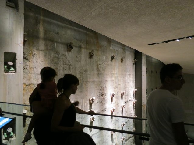 Visitors to the underground September 11 Museum view the massive retaining wall that once surrounded the towers' foundations. Seismic waves from the collapse first passing through this wall were detected more than 250 miles off. (Kevin Krajick) 
