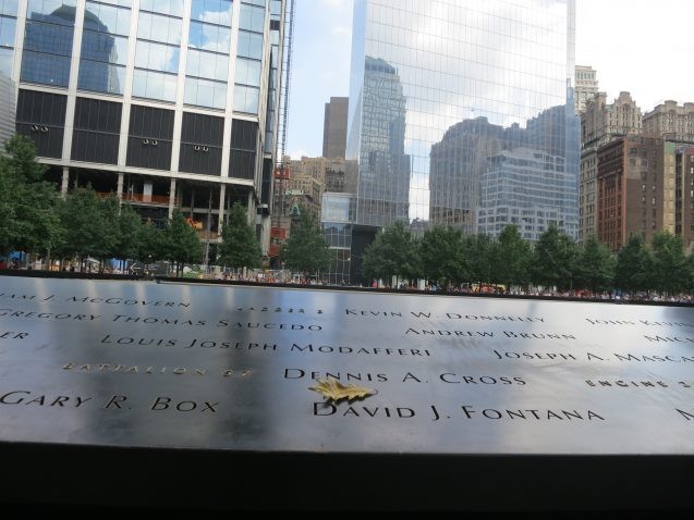 The September 11 Memorial. Just as this photo was taken, a leaf drifted from the sky to the inscription for Brooklyn fire fighter David J. Fontana. Fontana and 14 other from his squad perished when the south tower collapsed after they had climbed up