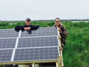 Keith and I pose by our newly installed solar panels . These will power both the GPS and the optical fiber strainmeters.