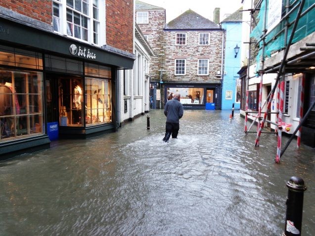 A man wades through a flooded Cornwall street after severe winter storms hit the United Kingdom. (Image: Pixabay)