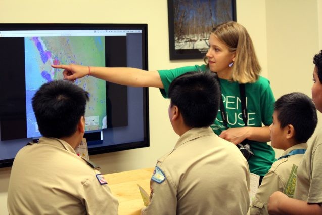 Anna Barth and a group of Boy Scouts looked for patterns in earthquake locations and sizes by watching years of eruptions compressed into a few minutes. The video they're watching is part of the Seismic Sound Lab's SeismoDome project.