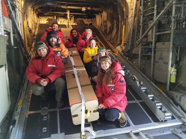 ROSETTA team gathered around the Alamo float as it is loaded on the plane for deployment in front of the Ross Ice Shelf. 