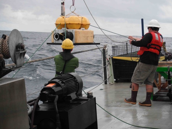 Deploying an ocean bottom seismometer from the R/V Oceanus. Photo: Lamont-Doherty