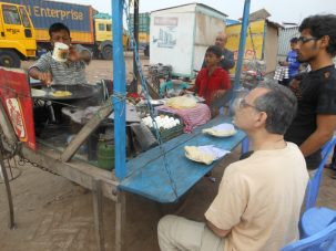 Having a breakfast of an omelet and paratha while waiting at the ferry ghat (dock) at Mawa.