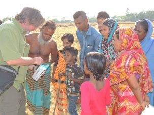 Chris providing a detailed explanation of what he is doing in English to people who only speak Bangla.