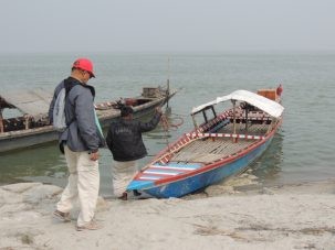 Humayun walks to the country boat we rented at Sirajganj to bring us across the river to the chars.