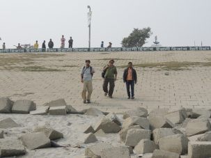 Chris, Dan, and Bulbul, our driver, walking down the embankment at Sirajganj. During the summer, the water level will reach the top of the embankment as the river flow increases by a factor of 10 or more.