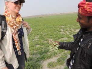 A local farmer shows Liz the peanuts he is growing on the char (behind them). Peanuts and lentils are common winter, or rabi, crops on the higher, drier parts of the char. The freshest peanuts we ever ate.