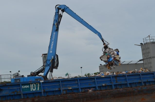 Along Newtown Creek, a crane loads recycled plastics onto a barge. Microbeads are only part of the pollution stream; larger objects often end up in the water by one route or another, where they break down into small bits.