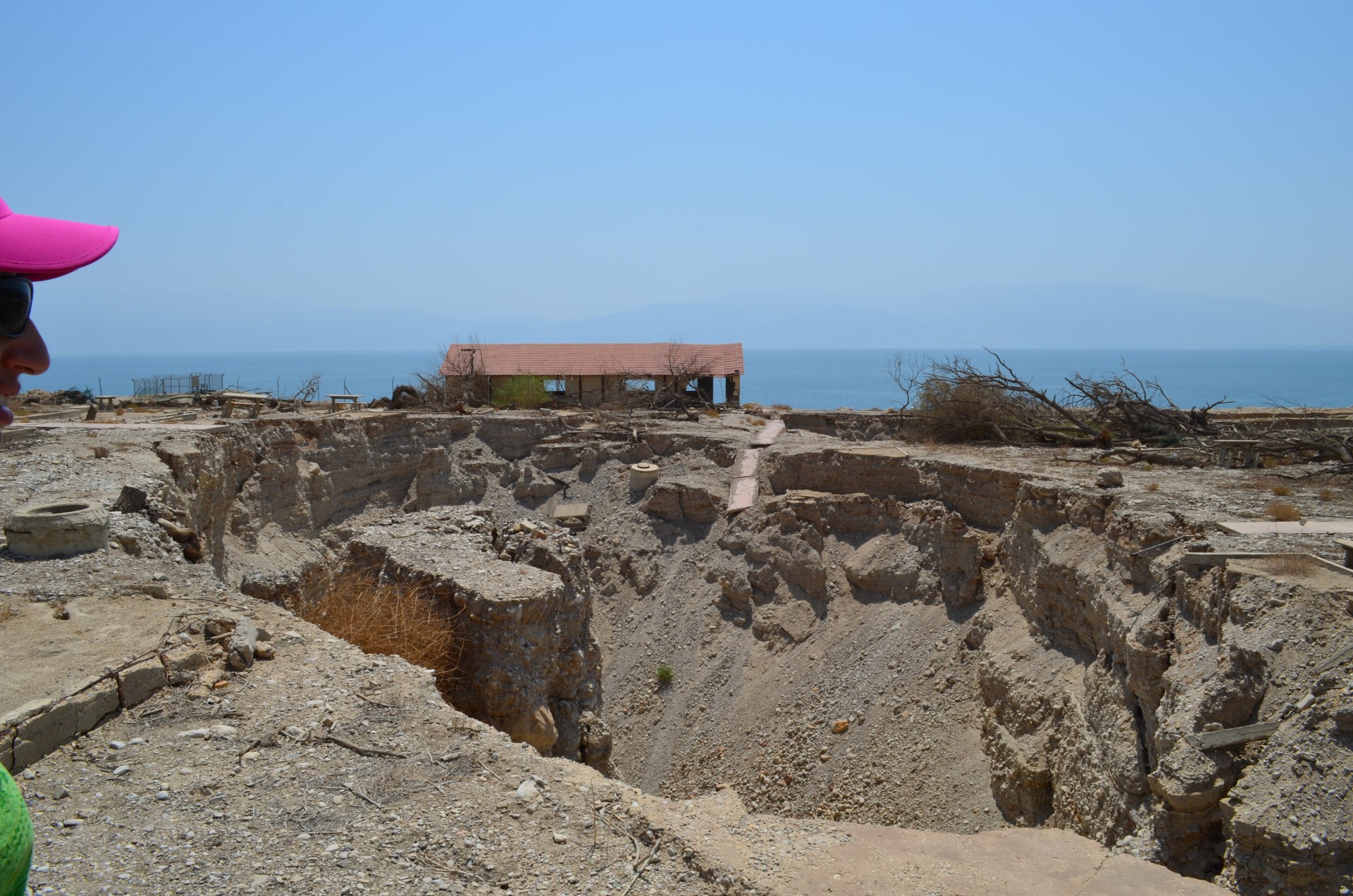 One result of dropping sea level: land along the shoreline is collapsing. Here, a sinkhole swallows the remains of a onetime Israeli beach resort.