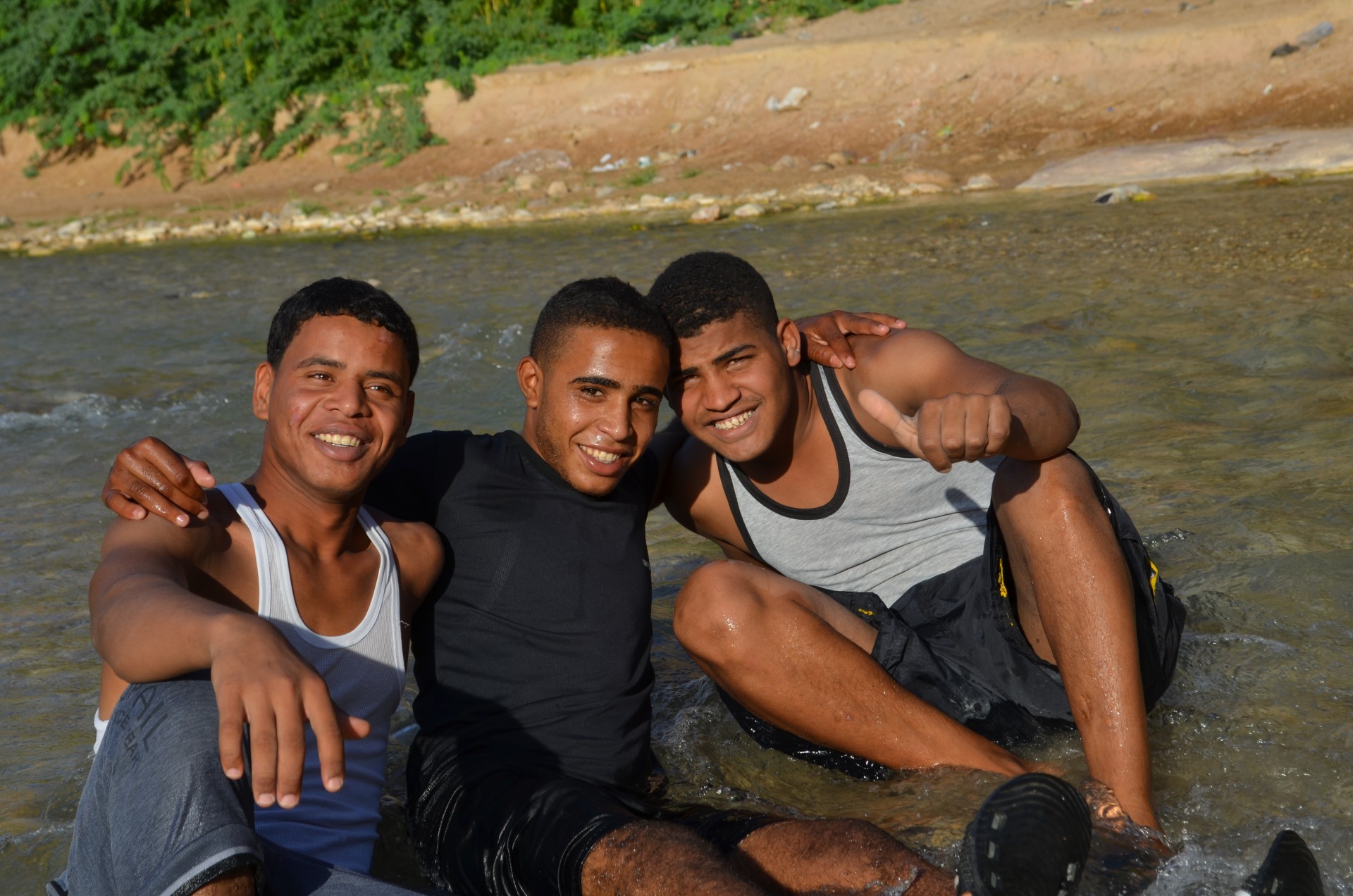 In another canyon, friends cool off in the 110-degree heat. Downstream, most of the water will be used for irrigation and household needs.