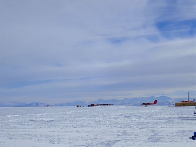 The landscape seems endless with ice shelf merging into white cloudy skies. The airplanes on the ice are close to the only relief.