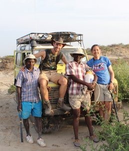 researchers in front of jeep