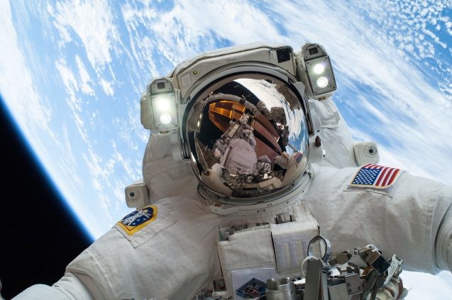 astronaut with earth behind