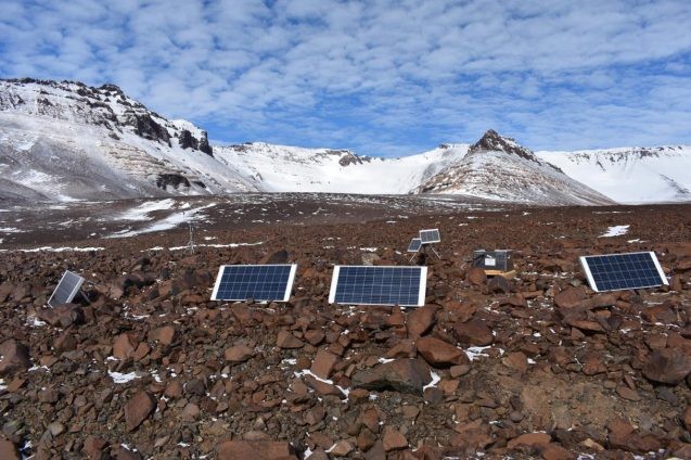 solar panels among barren rocks and hills