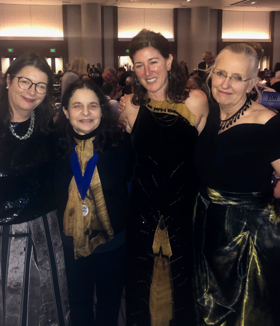 four women in evening gowns