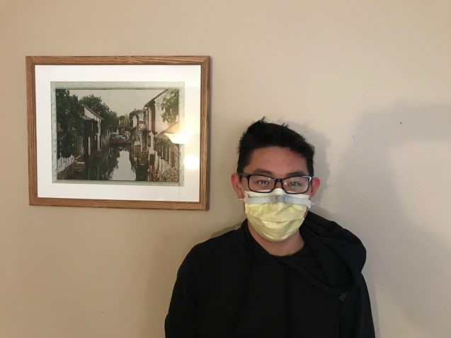 person wearing a face mask with nose clip