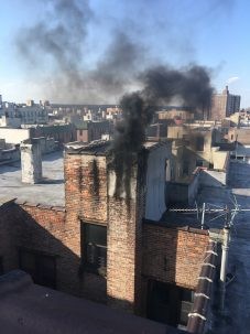 Soot and emissions pour out of a building in New York City