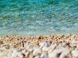 clean water and pebbles on beach