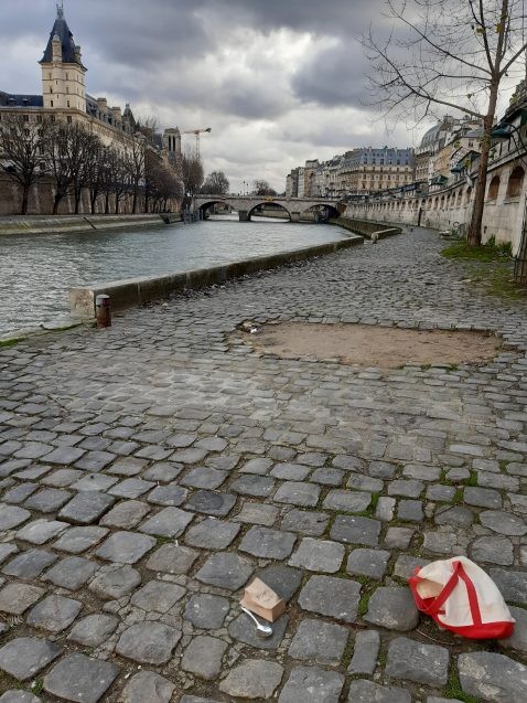 paper bag on sidewalk in paris