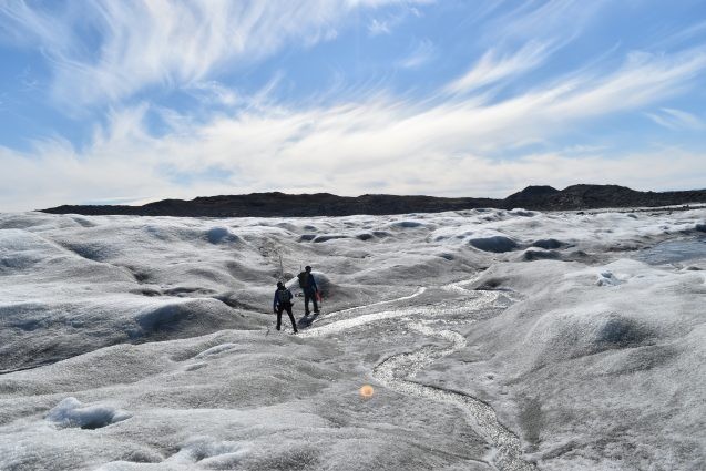 Researchers follow a meltwater stream in greenland