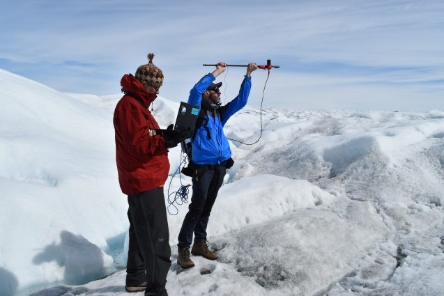 researchers measuring reflectivity of greenland ice sheet