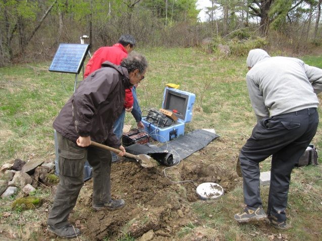 researchers burying equipment in the ground