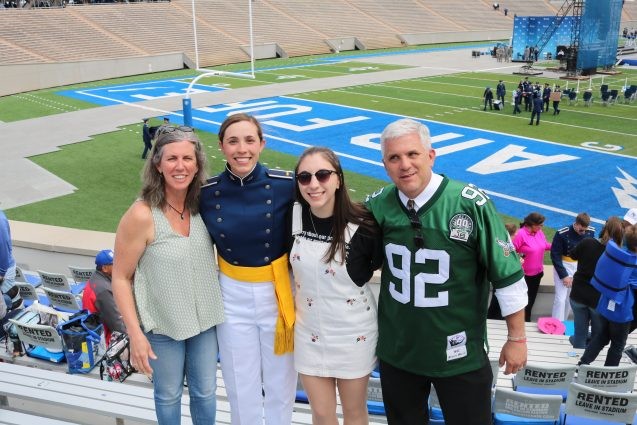 family photo in front of football field
