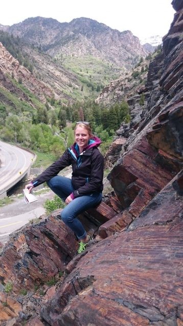 jacqueline austermann sitting on a rock outcrop
