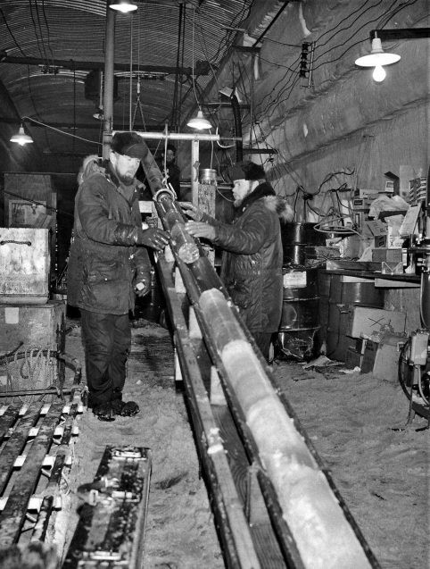 black and white photo of engineers with an ice core