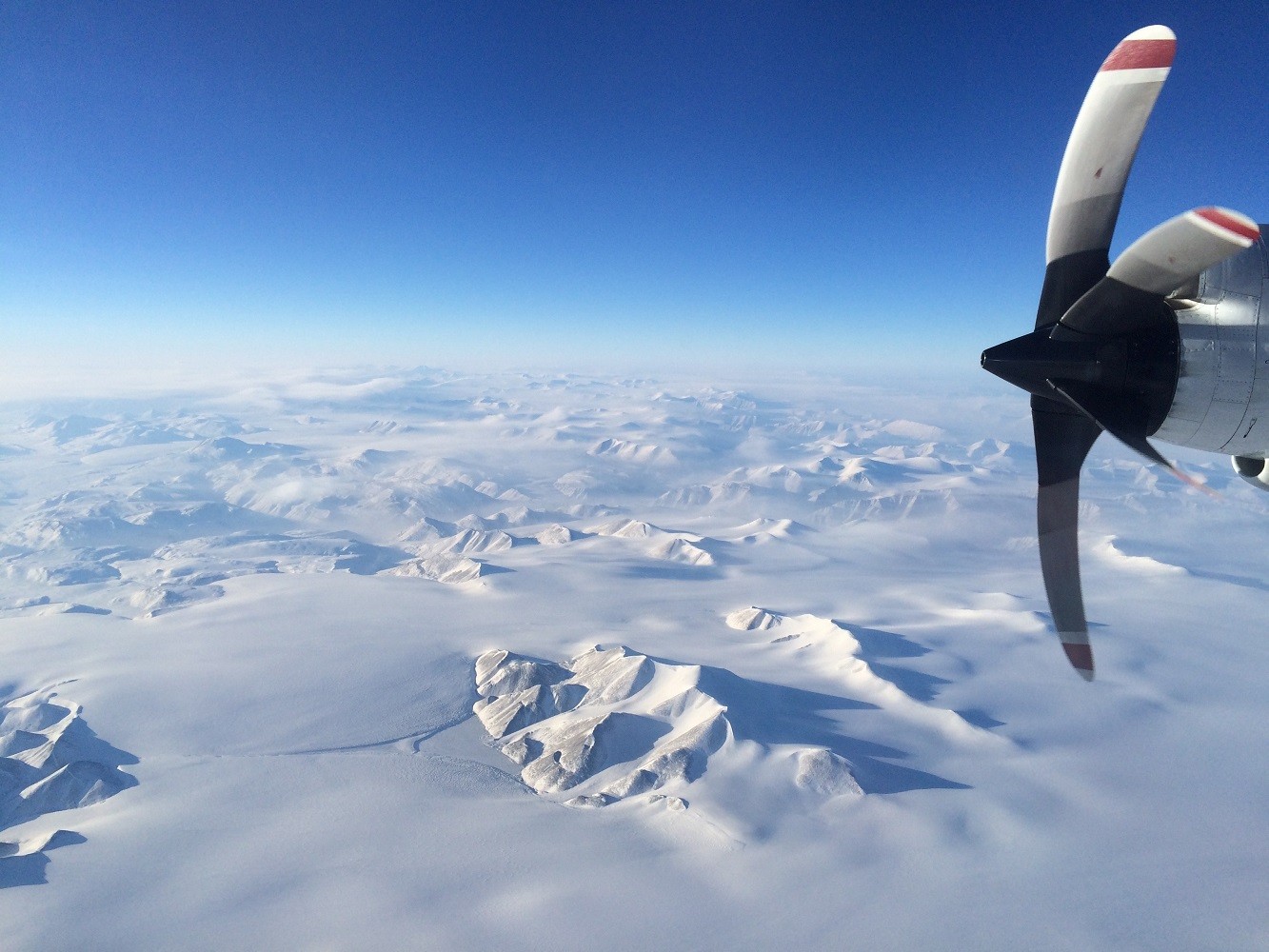 The Greenland Ice Sheet during <a href="https://blogs.ei.columbia.edu/features/ice-bridge/">Operation IceBridge</a>'s spring 2017 campaign. The mission monitors changes at the Earth's poles. Photo: Caitlin Dieck Locke OIB-P3_2017_Mountains - Caitlin Locke