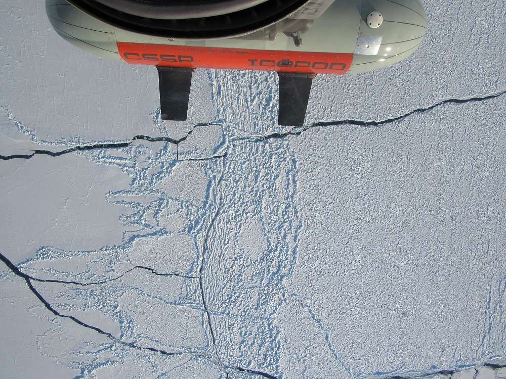 Attached to an aircraft, the <a href="https://blogs.ei.columbia.edu/features/decoding-the-mysteries-of-the-ross-ice-shelf/">ROSETTA mission</a>'s IcePod instrument soars over sea ice around Antarctica. The mission studied the Ross Ice Shelf. Photo: Caitlin Dieck Locke ROSETTA-IcePod_over_SeaIce_20171121_CDLocke - Caitlin Locke